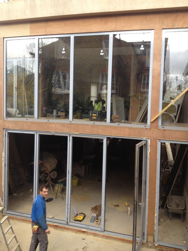 Aluminium bi-fold doors with two-storey glazing in East Sheen
