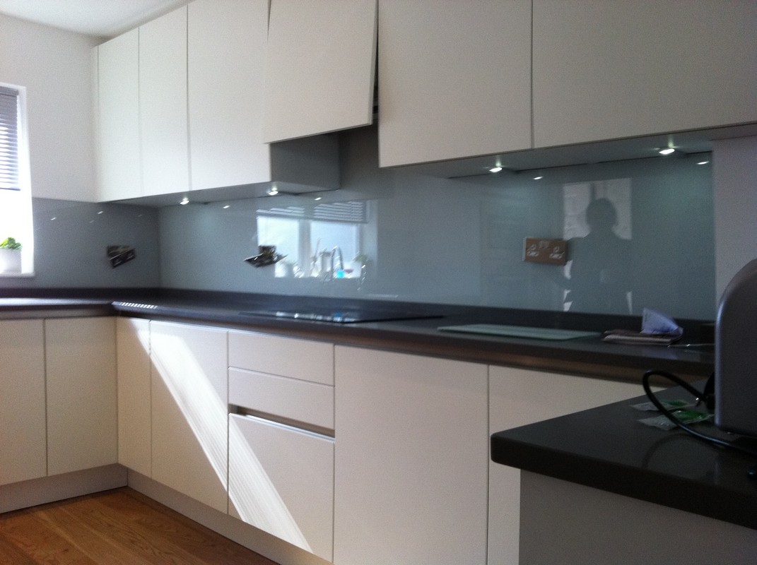 Grey glass kitchen splashback with LED lighting in East Sheen