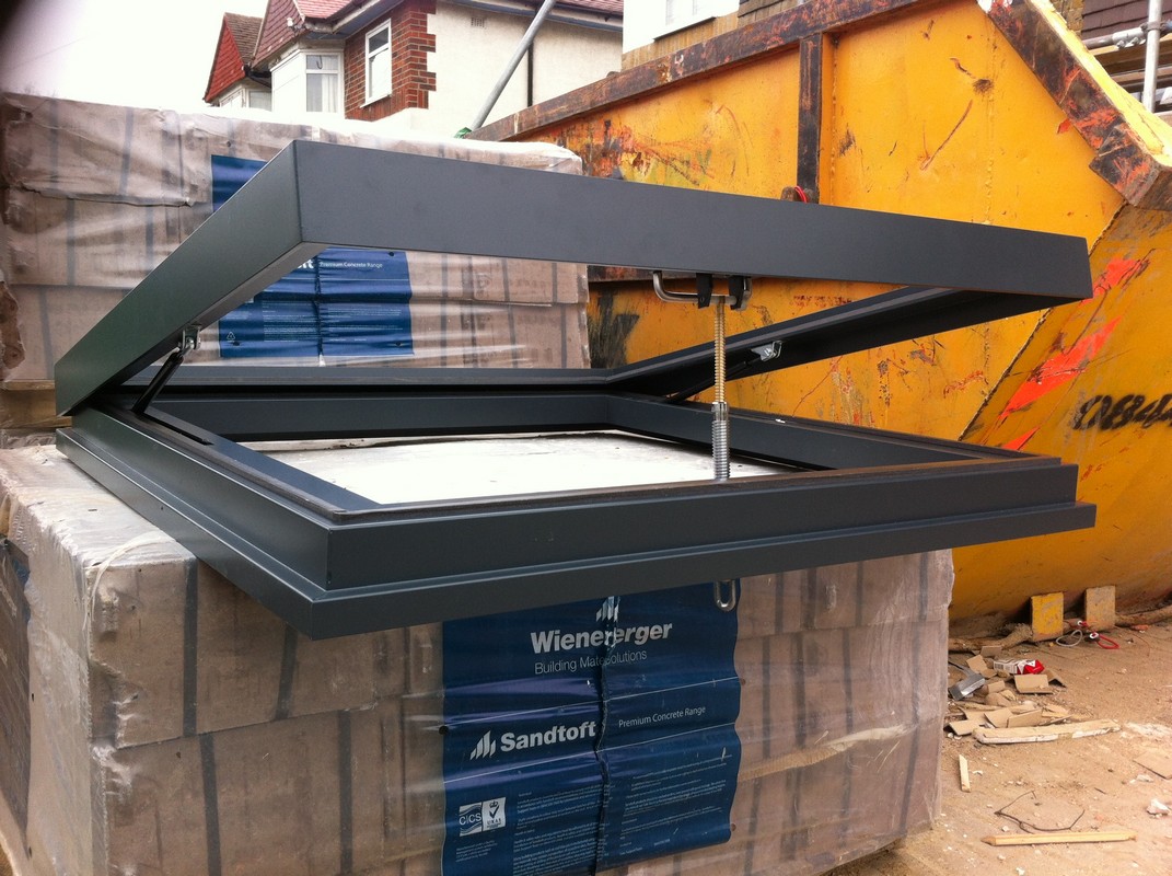 Opening flat roof skylight in anthracite grey installed in East Sheen
