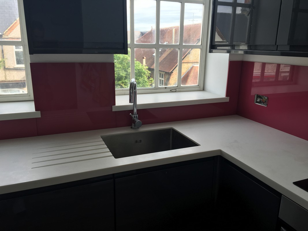Deep plum coloured glass splashback in modern East Sheen kitchen